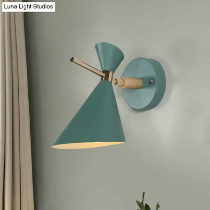 Decorbites black angle wall sconce with teal conical shade, brass arm and round teal wall mount on Tampa Home & Garden Store