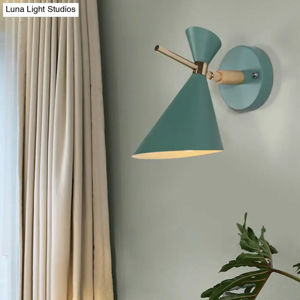 Black angle wall sconce with teal cone shade and brass arm on round wall mount on Tampa Home & Garden Store