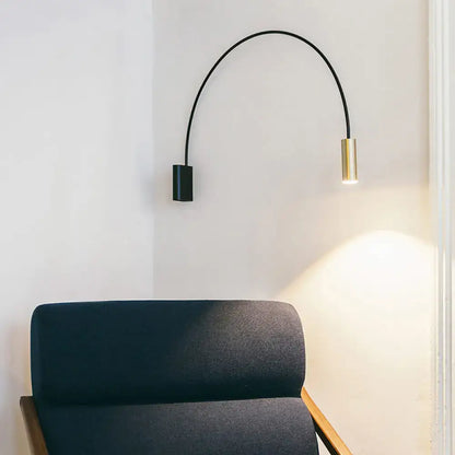Black arched LED wall light with black base and gold cylindrical lamp by Decorbites on Tampa Home & Garden Store