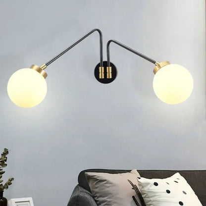 Black milk glass wall lamp Decorbites; double-armed wall light with globes and brass accents on Tampa Home & Garden Store