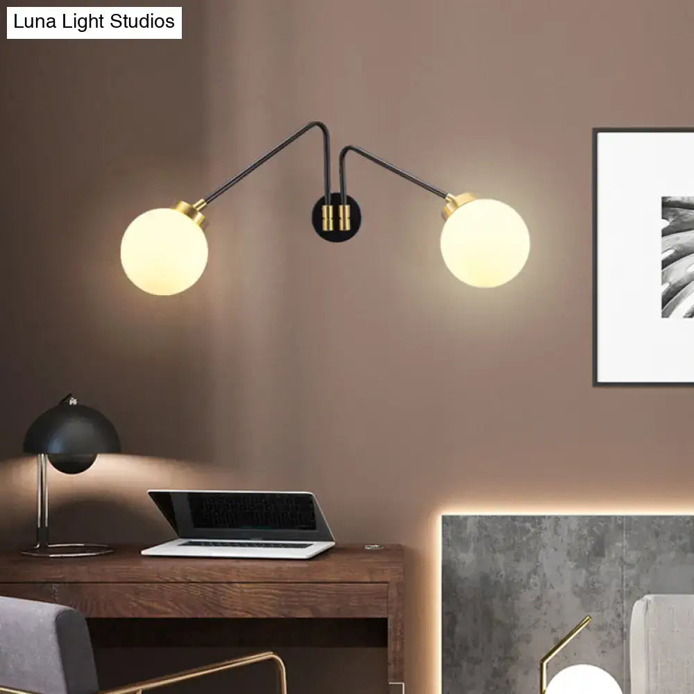 Black milk glass wall lamp with dual globe bulbs and brass accents on Tampa Home & Garden Store