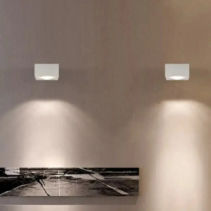 Decorbites rgb wall light pair, square LED sconces on beige wall casting downward glow on Tampa Home & Garden Store