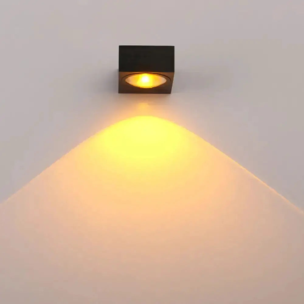 Modern black cube wall light with warm amber LED downlight on Tampa Home & Garden Store