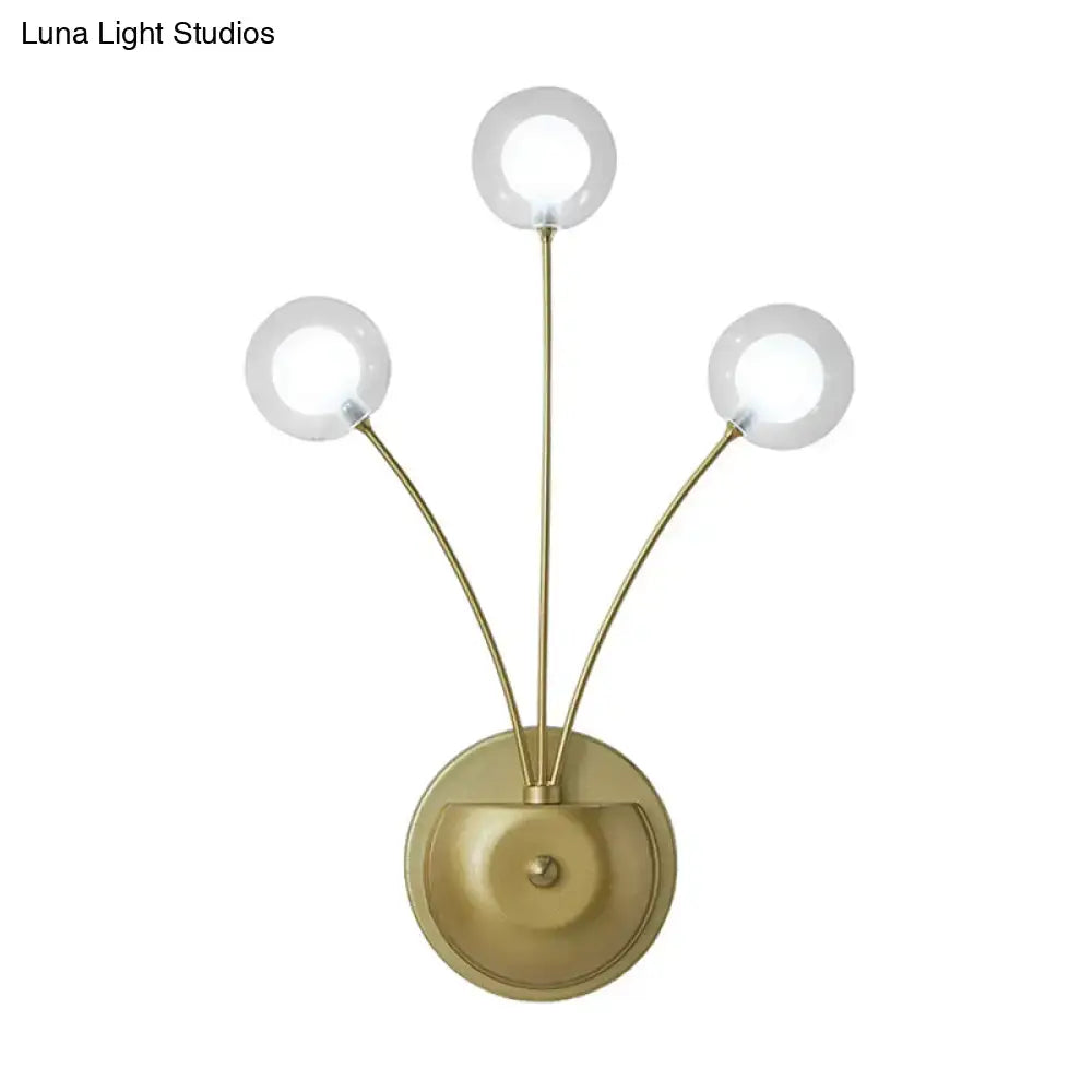 Black Iron Globe Sconce with three brass arms and round glass globes by Decorbites on Tampa Home & Garden Store