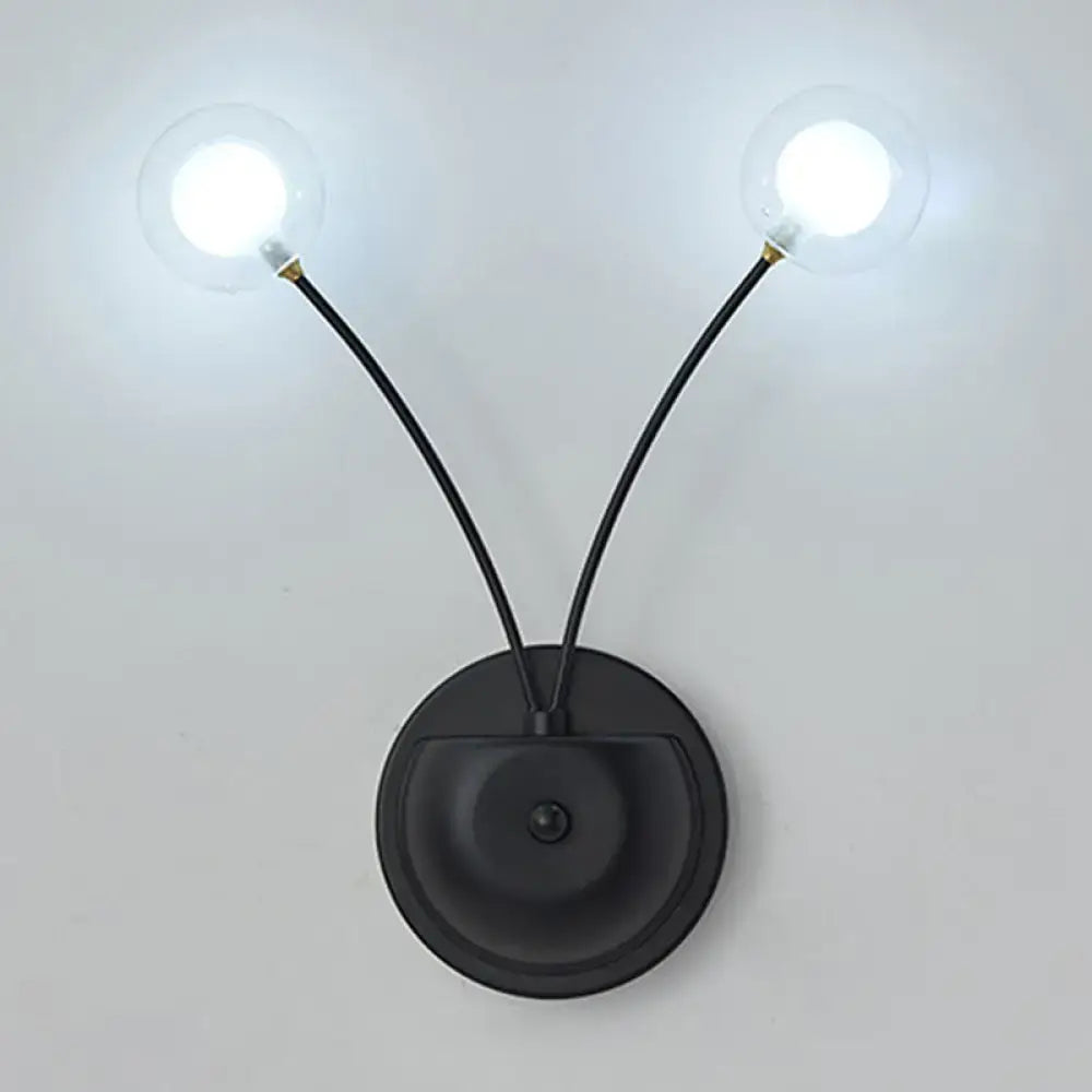 Black iron globe sconce with dual curved arms and clear glass bulbs Decorbites on Tampa Home & Garden Store