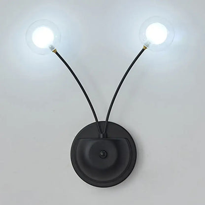 Black iron globe sconce with dual curved arms and clear glass bulbs Decorbites on Tampa Home & Garden Store