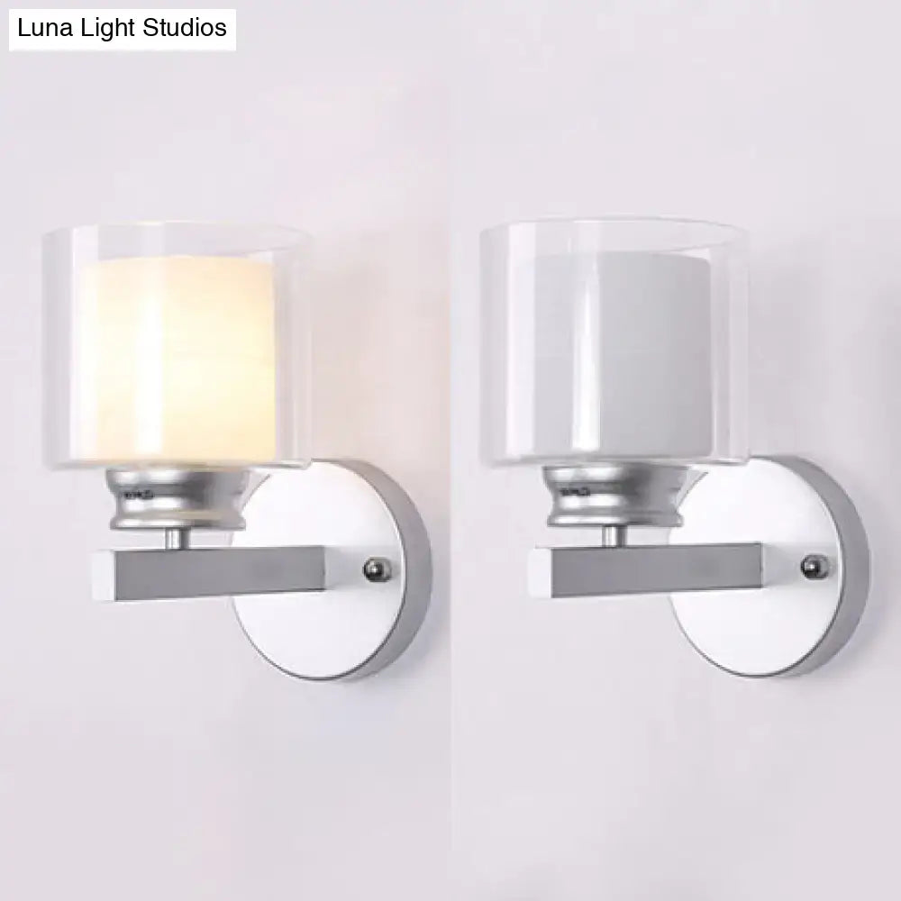 Pair of black chrome glass wall sconces with frosted cylindrical shades and rectangular arms on Tampa Home & Garden Store
