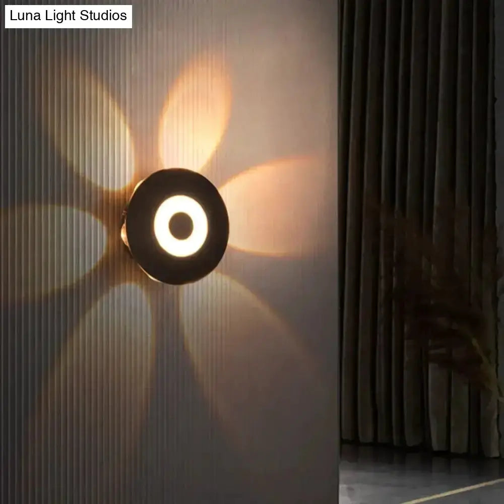 Modern black circular LED outdoor wall sconce by Decorbites with warm halo light on Tampa Home & Garden Store