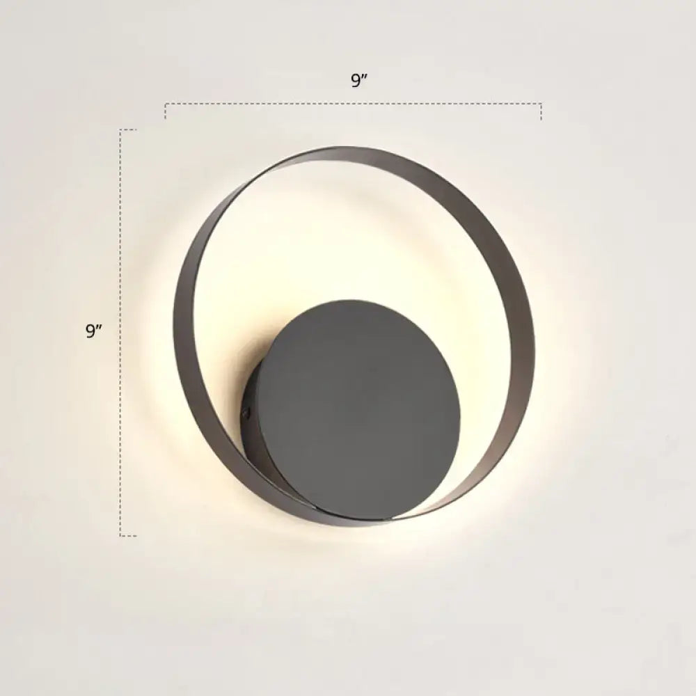 Black circular LED wall sconce with a metal ring and dark center disk, modern on Tampa Home & Garden Store