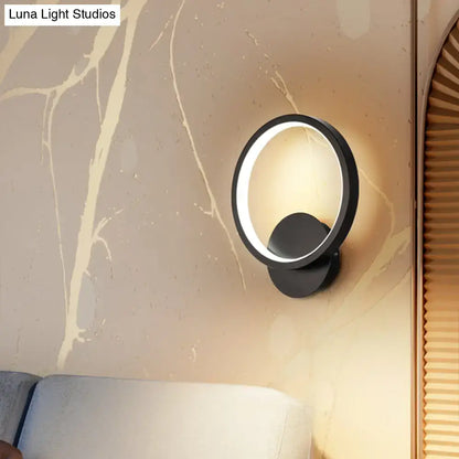 Black circular LED wall sconce by Decorbites with illuminated ring on beige wall on Tampa Home & Garden Store