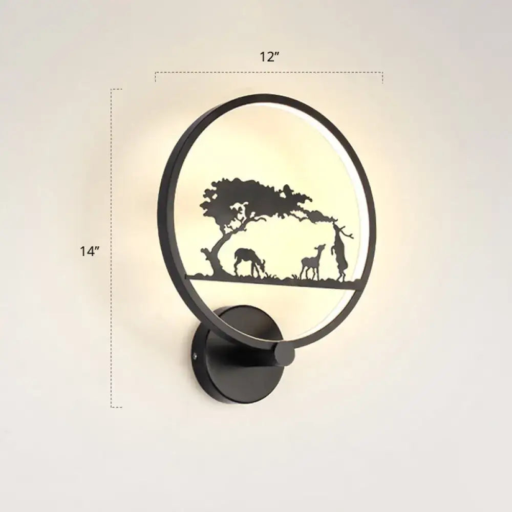 Black circular LED wall sconce by Decorbites with a nature silhouette scene on Tampa Home & Garden Store
