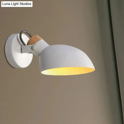Cream-white adjustable wall sconce with wood accent and warm glow on Tampa Home & Garden Store