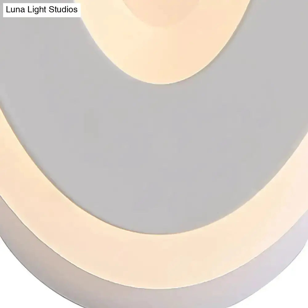 Decorbites oval LED wall lamp in black and cream, bedroom lighting with curved ring design on Tampa Home & Garden Store
