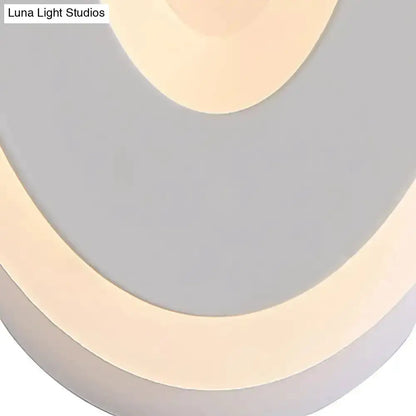 Decorbites oval LED wall lamp in black and cream, bedroom lighting with curved ring design on Tampa Home & Garden Store