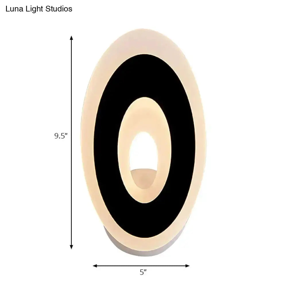 Modern oval LED wall lamp in black and cream for bedroom, circular wall sconce with warm glow on Tampa Home & Garden Store