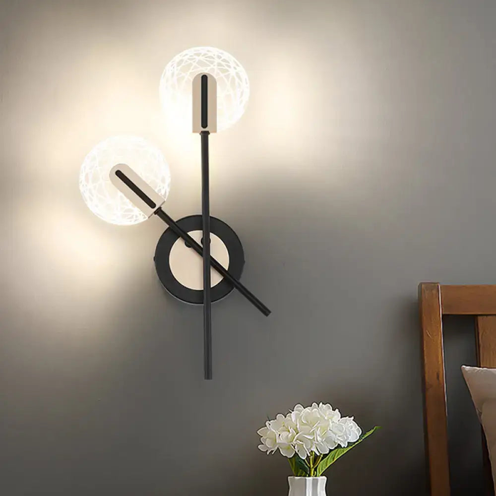 Black cast-iron wall sconce with two lattice-pattern glass globes and circular backplate on Tampa Home & Garden Store