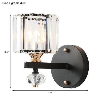 Black crystal drum sconce with faceted crystal shade on black metal wall plate, gold accents on Tampa Home & Garden Store