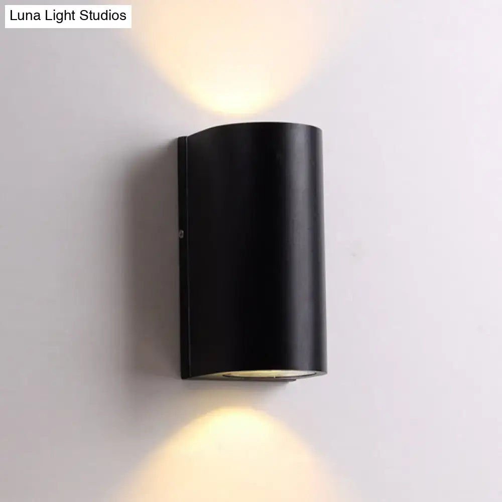 Black Cube LED Sconce, black metal wall lamp with cylindrical housing casting warm up and down light on Tampa Home & Garden Store