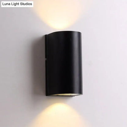 Black Cube LED Sconce, black metal wall lamp with cylindrical housing casting warm up and down light on Tampa Home & Garden Store