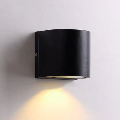 Black cube LED wall sconce by Decorbites, black metal cylinder with downward warm light on Tampa Home & Garden Store