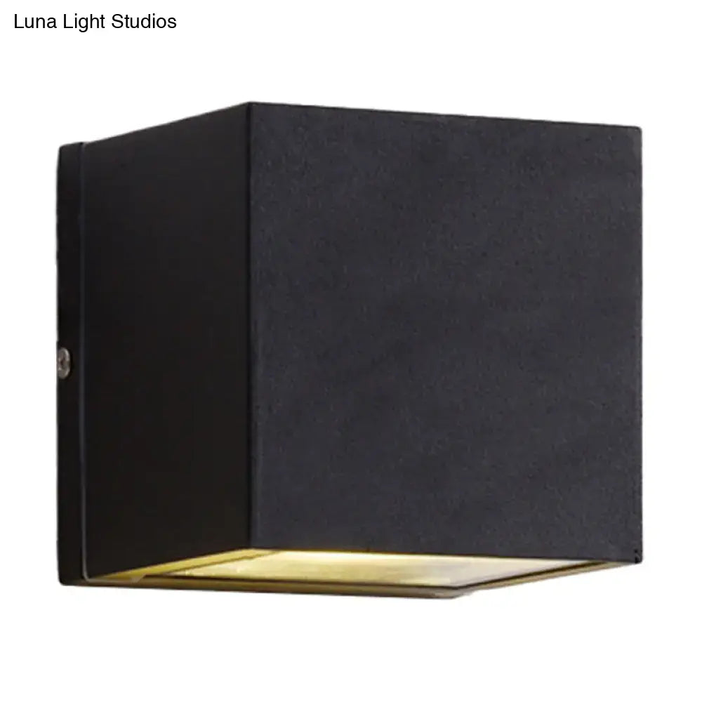 Decorbites black cube LED wall sconce with warm downward light on Tampa Home & Garden Store
