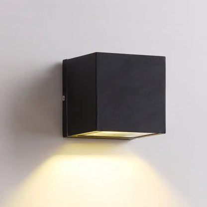 Black cube LED wall sconce by Decorbites, black metal with warm downward glow on Tampa Home & Garden Store