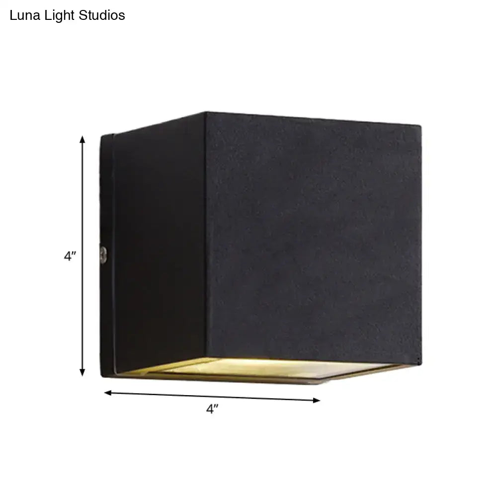 Black cube LED sconce by Decorbites, 4-inch black metal with warm gold bottom glow on Tampa Home & Garden Store
