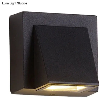 Black Cube LED Sconce in matte black metal by Decorbites, emits warm light on Tampa Home & Garden Store