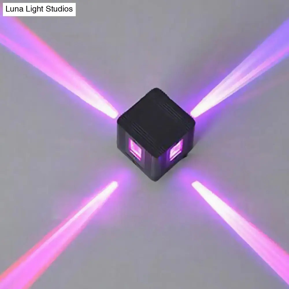 Black cubic LED sconce by Decorbites emitting purple light beams in four directions on Tampa Home & Garden Store