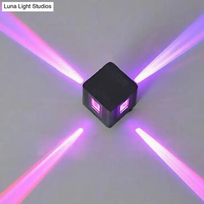 Black cubic LED sconce by Decorbites emitting purple light beams in four directions on Tampa Home & Garden Store