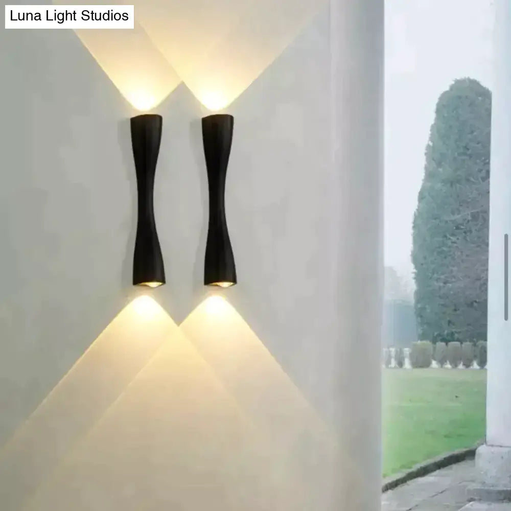 Decorbites black curved IP65 outdoor wall sconce pair with warm up and down light on white wall on Tampa Home & Garden Store