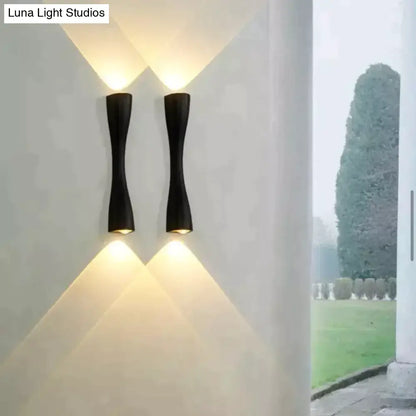 Decorbites black curved IP65 outdoor wall sconce pair with warm up and down light on white wall on Tampa Home & Garden Store