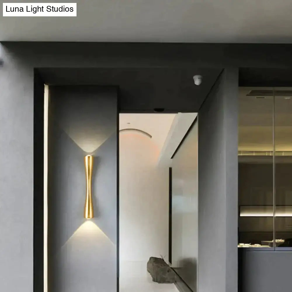 Black Curved IP65 Outdoor Wall Sconce with brass-gold finish mounted on dark exterior wall on Tampa Home & Garden Store