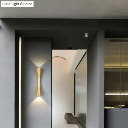 Black Curved IP65 Outdoor Wall Sconce with brass-gold finish mounted on dark exterior wall on Tampa Home & Garden Store