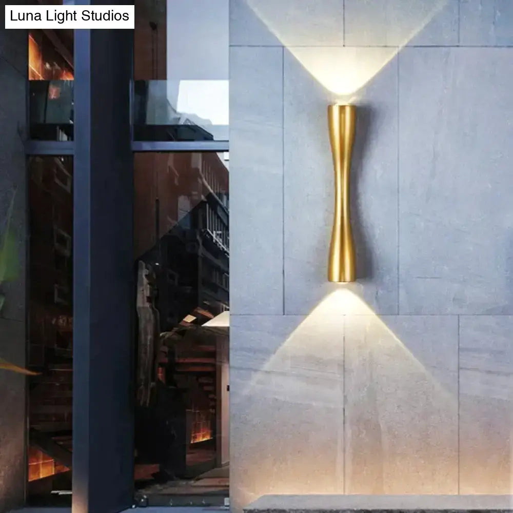 Outdoor wall sconce gold curved IP65 by Decorbites mounted on stone wall with uplight on Tampa Home & Garden Store