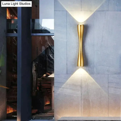 Outdoor wall sconce gold curved IP65 by Decorbites mounted on stone wall with uplight on Tampa Home & Garden Store