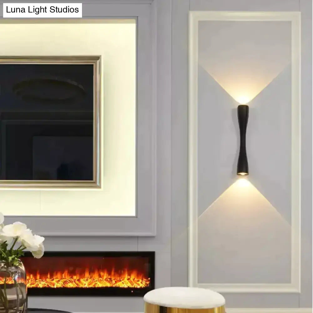 Black curved IP65 outdoor wall sconce by Decorbites with uplight and downlight illumination on Tampa Home & Garden Store