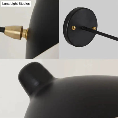 Modern black duckbill shade wall lamp with curved arm, brass connector detail on Tampa Home & Garden Store