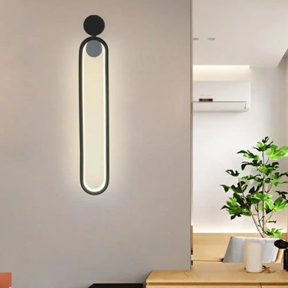 Black elliptical LED wall sconce by Decorbites; slim oval design, modern matte finish on Tampa Home & Garden Store