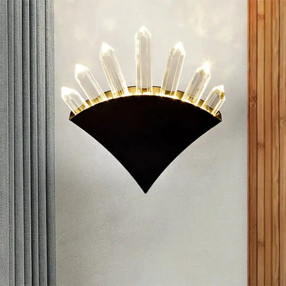Modern black wall sconce with crystal prisms fanning upward, bedroom lighting on Tampa Home & Garden Store