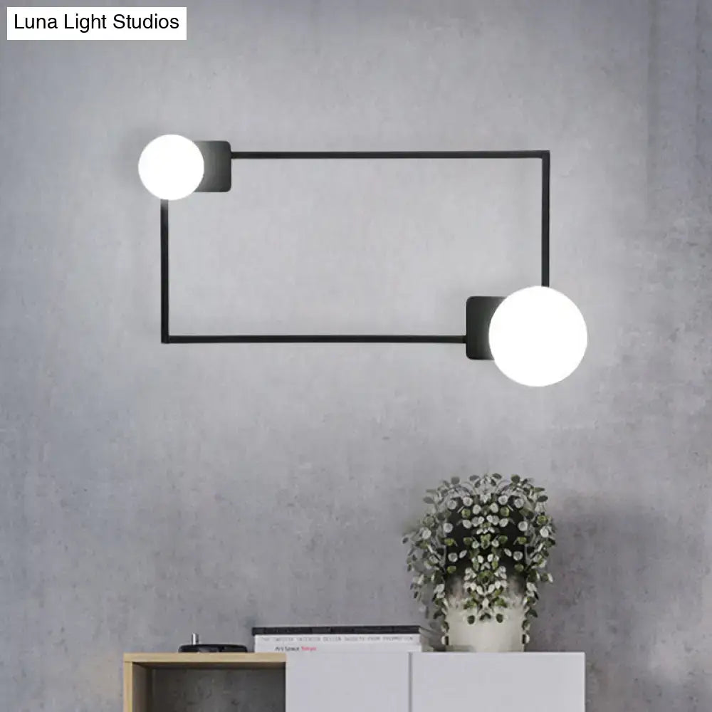 Decorbites black rectangle glass globe sconce with dual white globes mounted to a metal frame on Tampa Home & Garden Store