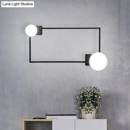 Decorbites black rectangle glass globe sconce with dual white globes mounted to a metal frame on Tampa Home & Garden Store