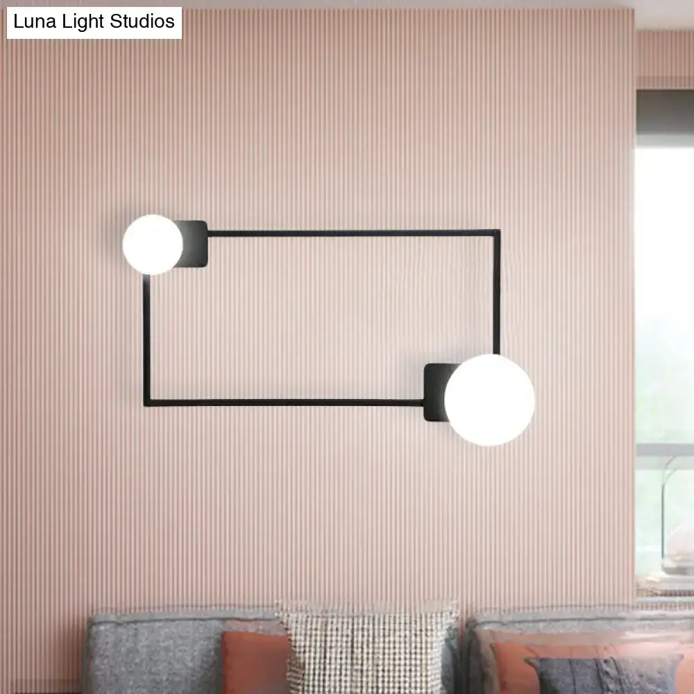 Black rectangle glass globe sconce with dual white globes on slim wall-mounted frame on Tampa Home & Garden Store