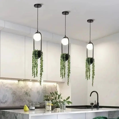 Modern black flower pot pendant lights (3) with trailing greenery over white kitchen island on Tampa Home & Garden Store