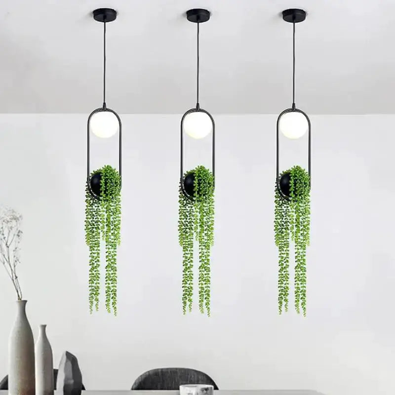 Three modern black flower pot pendant lights with trailing greenery planters for dining room on Tampa Home & Garden Store