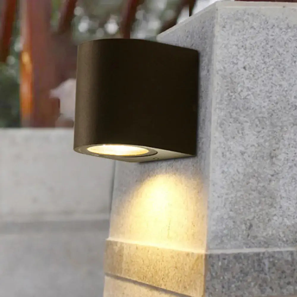 Black Decorbites outdoor patio two-light wall sconce with cylindrical housing on stone pillar on Tampa Home & Garden Store