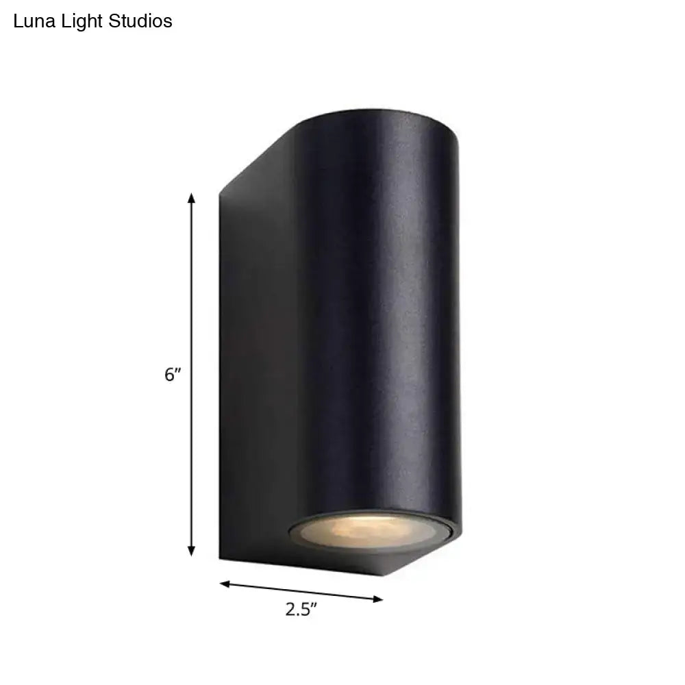 Black metal outdoor patio wall sconce, cylindrical housing with downward light on Tampa Home & Garden Store