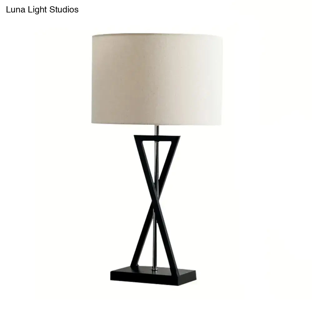 Black Nightstand Drum Lamp with an X-shaped black metal base and beige fabric shade on Tampa Home & Garden Store