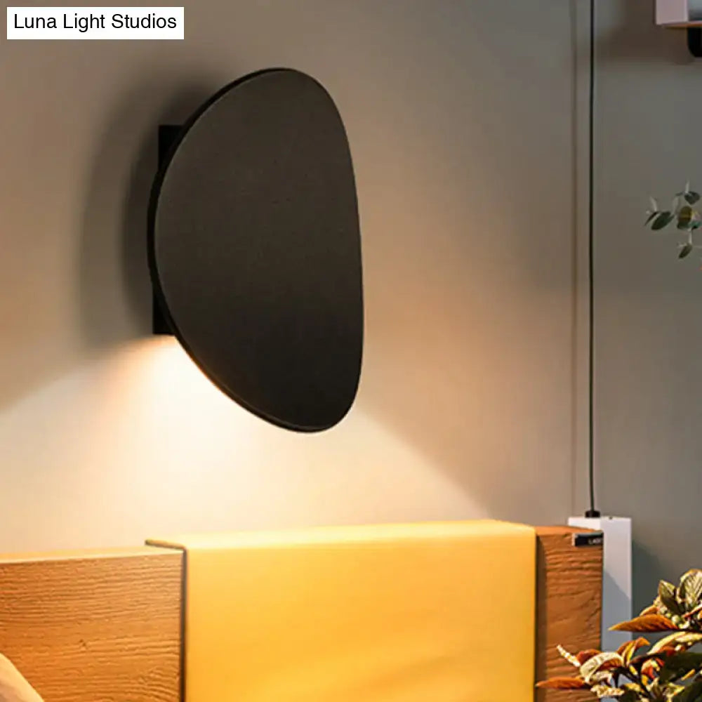 Black Geometric Wall Fixture, round matte black metal wall sconce with warm downward light on Tampa Home & Garden Store