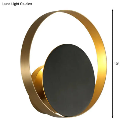 Black brass circular sconce by Decorbites with gold ring and dark center disc on Tampa Home & Garden Store